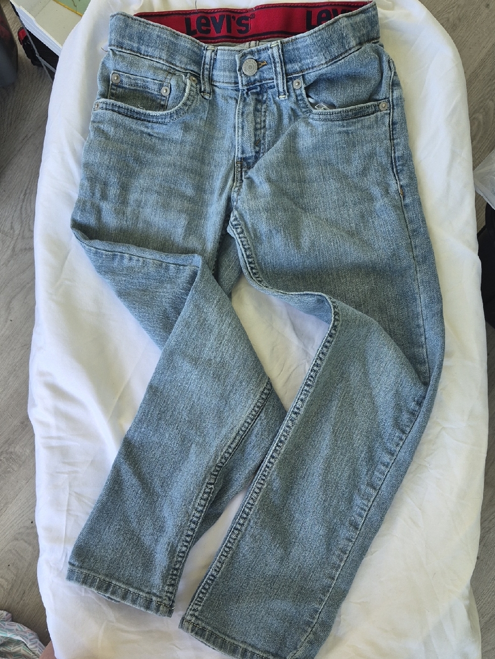 Levi's Light Blue Denim Jeans with Red Waistband Accent